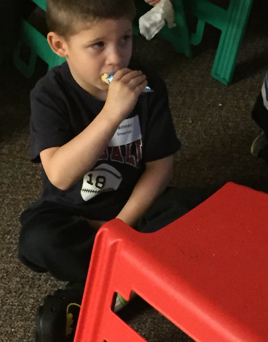 Tanner quietly enjoys the show and snack.