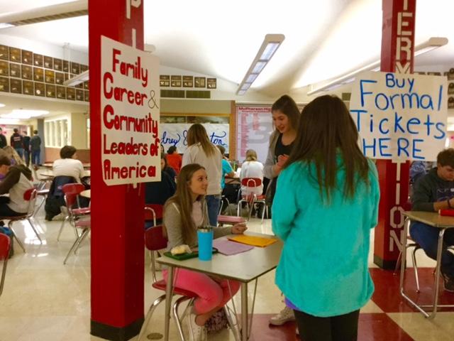 During lunch, MHS students wait to buy a carnation or cookie from the FCCLA stand. 