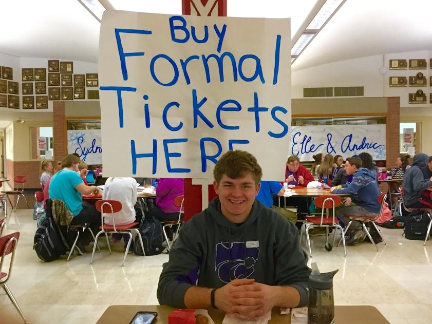 Selling tickets, senior Thomas Smith watches the table during lunch. 
