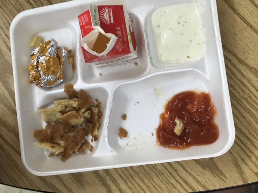 Student lunches ketchup with bread and juice 