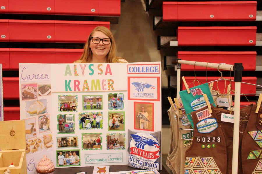 Alyssa Kramer showcases her many patches from girl scouting and the college she will be attending. 