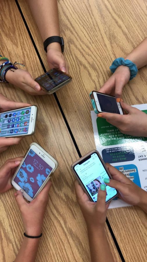 Teenagers on their phones.