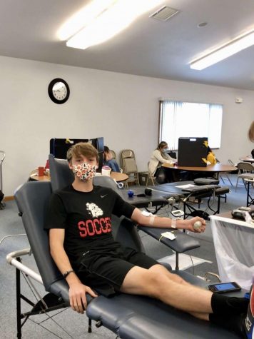 Junior, Josh Everhart, gives blood at drive. 